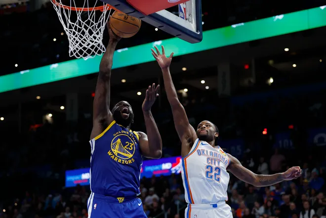 Mar 7, 2026; Oklahoma City, Oklahoma, USA; Golden State Warriors forward Draymond Green (23) goes up for a basket beside Oklahoma City Thunder guard Cason Wallace (22) during the second half at Paycom Center. Mandatory Credit: Alonzo Adams-Imagn Images