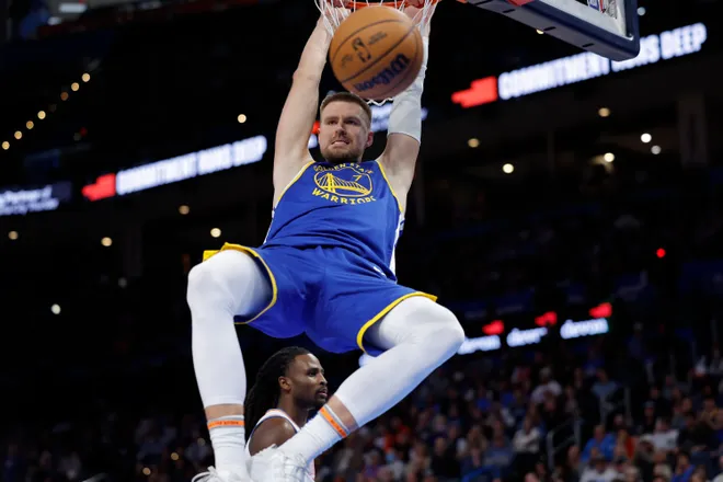 Mar 7, 2026; Oklahoma City, Oklahoma, USA; Golden State Warriors forward/center Kristaps Porziņģis (7) dunks against the Oklahoma City Thunder during the second half at Paycom Center. Mandatory Credit: Alonzo Adams-Imagn Images