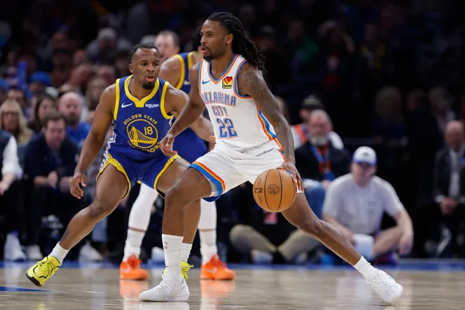 Mar 7, 2026; Oklahoma City, Oklahoma, USA; Oklahoma City Thunder guard Cason Wallace (22) drives past Golden State Warriors guard Lj Cryer (18) during the second half at Paycom Center. Mandatory Credit: Alonzo Adams-Imagn Images