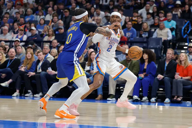 Mar 7, 2026; Oklahoma City, Oklahoma, USA; Oklahoma City Thunder guard Shai Gilgeous-Alexander (2) moves the ball as Golden State Warriors guard Gary Payton II (0) defends during the first half at Paycom Center. Mandatory Credit: Alonzo Adams-Imagn Images