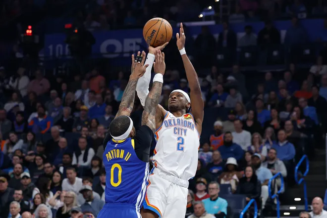 Mar 7, 2026; Oklahoma City, Oklahoma, USA; Oklahoma City Thunder guard Shai Gilgeous-Alexander (2) shoots as Golden State Warriors guard Gary Payton II (0) defends during the first half at Paycom Center. Mandatory Credit: Alonzo Adams-Imagn Images