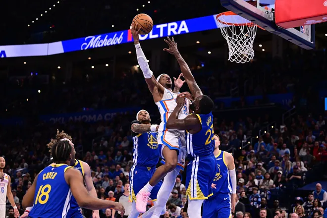 OKLAHOMA CITY, OKLAHOMA - MARCH 7: Shai Gilgeous-Alexander #2 of the Oklahoma City Thunder attempts a shot in front of Draymond Green #23 of the Golden State Warriors during the second half at Paycom Center on March 7, 2026 in Oklahoma City, Oklahoma. NOTE TO USER: User expressly acknowledges and agrees that, by downloading and or using this photograph, User is consenting to the terms and conditions of the Getty Images License Agreement. (Photo by Joshua Gateley/Getty Images)