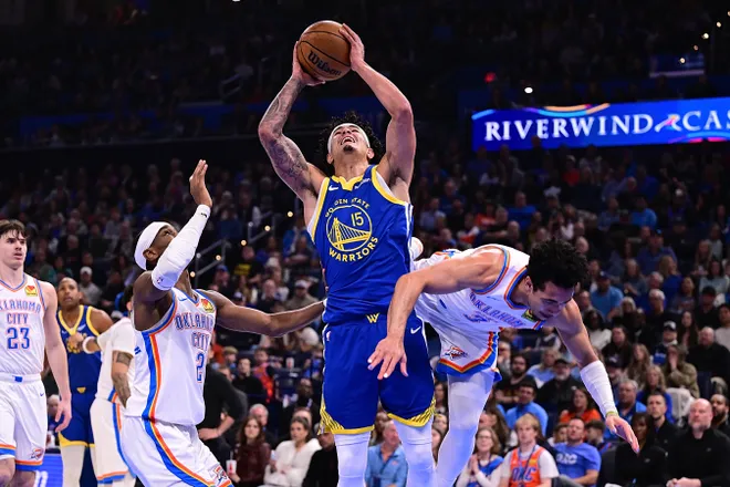 OKLAHOMA CITY, OKLAHOMA - MARCH 7: Gui Santos #15 of the Golden State Warriors attempts a shot in front of Shai Gilgeous-Alexander #2 and Jared McCain #3 of the Oklahoma City Thunder during the first half at Paycom Center on March 7, 2026 in Oklahoma City, Oklahoma. NOTE TO USER: User expressly acknowledges and agrees that, by downloading and or using this photograph, User is consenting to the terms and conditions of the Getty Images License Agreement. (Photo by Joshua Gateley/Getty Images)