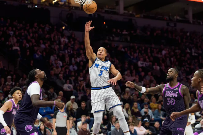 Mar 7, 2026; Minneapolis, Minnesota, USA; Orlando Magic guard Desmond Bane (3) shoots over Minnesota Timberwolves center Naz Reid (11) in the first quarter at Target Center. Mandatory Credit: Matt Blewett-Imagn Images