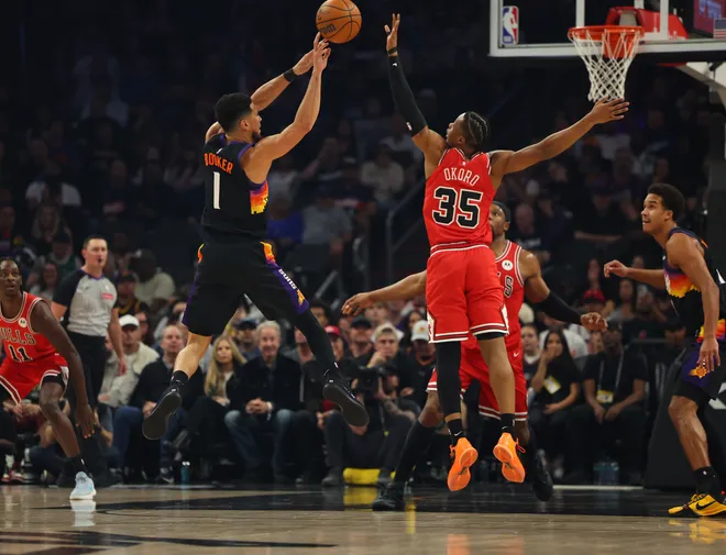 Mar 5, 2026; Phoenix, Arizona, USA; Phoenix Suns guard Devin Booker (1) passes the ball against Chicago Bulls forward Isaac Okoro (35) in the first quarter at Mortgage Matchup Center. Mandatory Credit: Anna Carrington-Imagn Images
