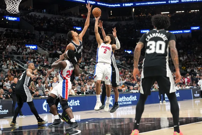 Mar 5, 2026; San Antonio, Texas, USA; Detroit Pistons guard Cade Cunningham (2) shoots over San Antonio Spurs forward Victor Wembanyama (1) during the second half at Frost Bank Center. Mandatory Credit: Scott Wachter-Imagn Images