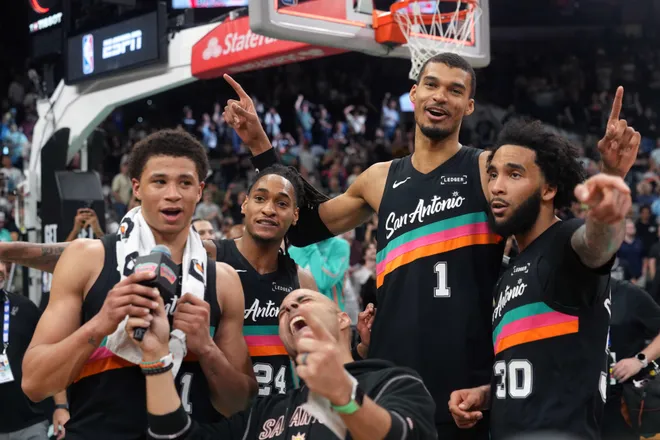 Mar 6, 2026; San Antonio, Texas, USA; San Antonio Spurs forward Victor Wembanyama (1) reacts with teammates forwards Carter Bryant (11) and Julian Champagnie (30) and guard Devin Vassell (24) after securing a comeback victory over the Los Angeles Clippers at Frost Bank Center. Mandatory Credit: Scott Wachter-Imagn Images