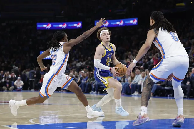 Mar 7, 2026; Oklahoma City, Oklahoma, USA; Golden State Warriors guard Brandin Podziemski (2) drives to the basket between Oklahoma City Thunder guard Cason Wallace (22) and forward Jaylin Williams (6) during the second half at Paycom Center.