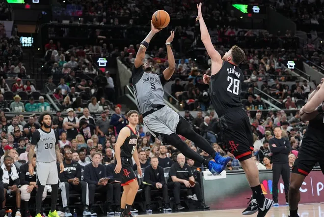 Mar 8, 2026; San Antonio, Texas, USA; San Antonio Spurs guard Stephon Castle (5) shoots after being fouled by Houston Rockets center Alperen Sengun (28) in the second half at Frost Bank Center.
