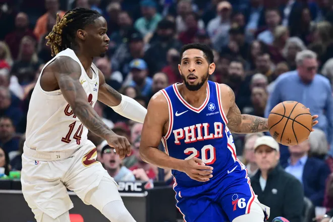 Mar 9, 2026; Cleveland, Ohio, USA; Philadelphia 76ers guard Cameron Payne (20) drives to the basket against Cleveland Cavaliers guard Keon Ellis (14) during the first half at Rocket Arena. Mandatory Credit: Ken Blaze-Imagn Images