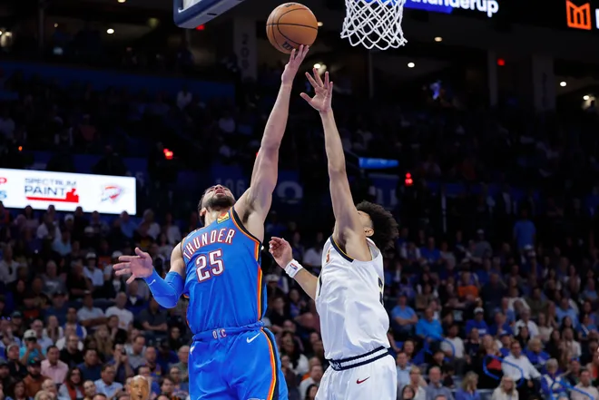 Mar 9, 2026; Oklahoma City, Oklahoma, USA; Oklahoma City Thunder guard Ajay Mitchell (25) goes up for a basket as Denver Nuggets guard Jamal Murray (27) defends the shot during the second half at Paycom Center. Mandatory Credit: Alonzo Adams-Imagn Images