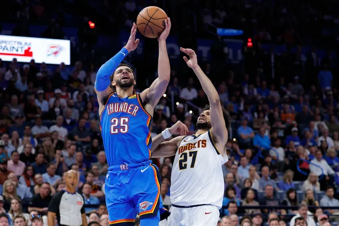 Mar 9, 2026; Oklahoma City, Oklahoma, USA; Oklahoma City Thunder guard Ajay Mitchell (25) goes up for a basket beside Denver Nuggets guard Jamal Murray (27) during the second half at Paycom Center. Mandatory Credit: Alonzo Adams-Imagn Images