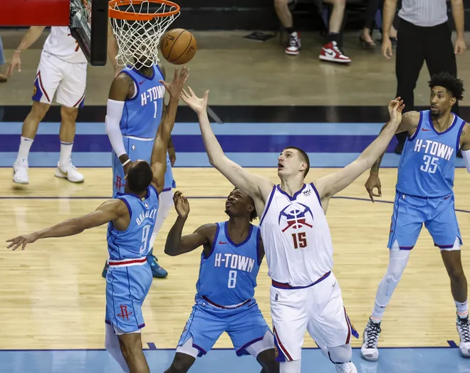 Apr 16, 2021; Houston, Texas, USA; Houston Rockets guard Avery Bradley (9) and Denver Nuggets center Nikola Jokic (15) attempt to get a rebound during the second quarter at Toyota Center. Mandatory Credit: Troy Taormina-USA TODAY Sports