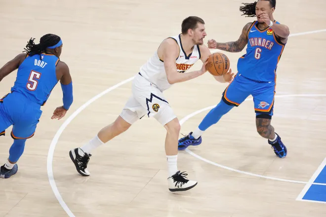 Mar 9, 2026; Oklahoma City, Oklahoma, USA; Denver Nuggets center Nikola Jokić (15) drives between Oklahoma City Thunder guard Luguentz Dort (5) and forward Jaylin Williams (6) during the first quarter at Paycom Center. Mandatory Credit: Alonzo Adams-Imagn Images