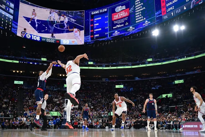 Mar 9, 2026; Inglewood, California, USA; Los Angeles Clippers guard Darius Garland (10) shoots against New York Knicks center Karl-Anthony Towns (32) during the second half at Intuit Dome.