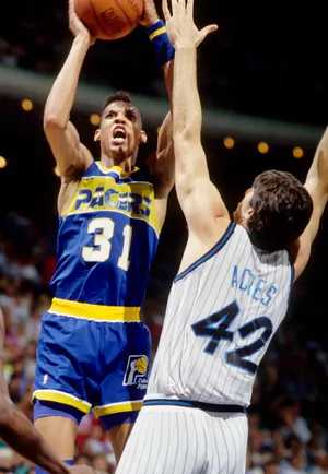 Indiana Pacers guard Reggie Miller shoots over Orlando Magic center Mark Acres.