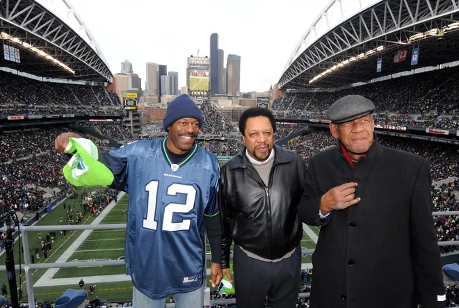 Gus Williams, John Johnson and Fred Brown raise the 12th man flag before the NFL game at Qwest Field between the San Francisco 49ers and Seattle Seahawks to honor the Seattle Super Sonics 1979 NBA championship.