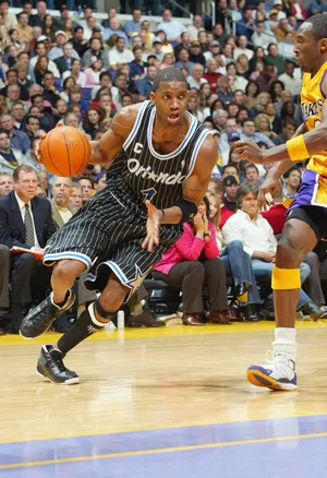 Tracy McGrady of the Orlando Magic drives past Kobe Bryant.