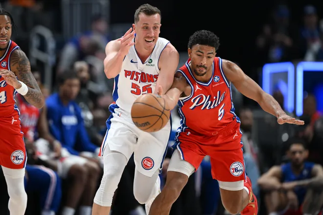 Mar 12, 2026; Detroit, Michigan, USA; Philadelphia 76ers guard Quentin Grimes (5) knocks the ball away from Detroit Pistons forward Duncan Robinson (55) in the first half at Little Caesars Arena. Mandatory Credit: Lon Horwedel-Imagn Images