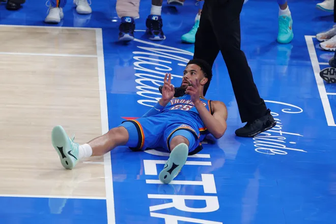 Mar 12, 2026; Oklahoma City, Oklahoma, USA; Oklahoma City Thunder guard Ajay Mitchell (25) gestures after scoring against the Boston Celtics and falling to the court during the first quarter at Paycom Center. Mandatory Credit: Alonzo Adams-Imagn Images