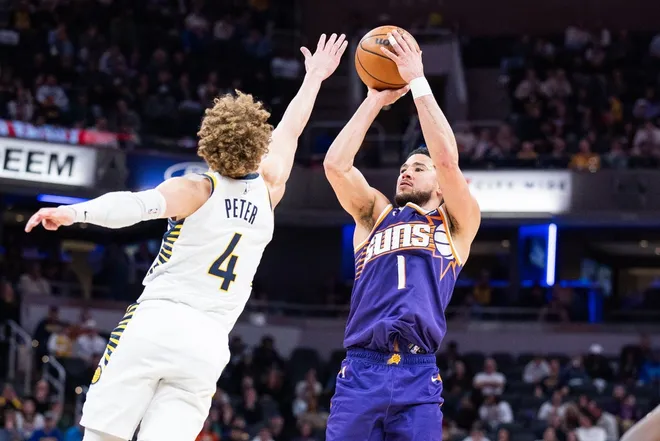 Mar 12, 2026; Indianapolis, Indiana, USA; Phoenix Suns guard Devin Booker (1) shoots the ball while Indiana Pacers guard Taelon Peter (4) defends in the second half at Gainbridge Fieldhouse.