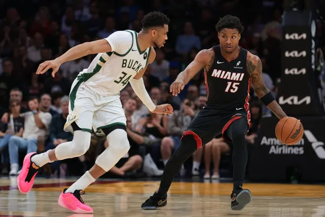 Mar 12, 2026; Miami, Florida, USA; Miami Heat forward Myron Gardner (15) dribbles the basketball as Milwaukee Bucks forward Giannis Antetokounmpo (34) defends during the fourth quarter at Kaseya Center.