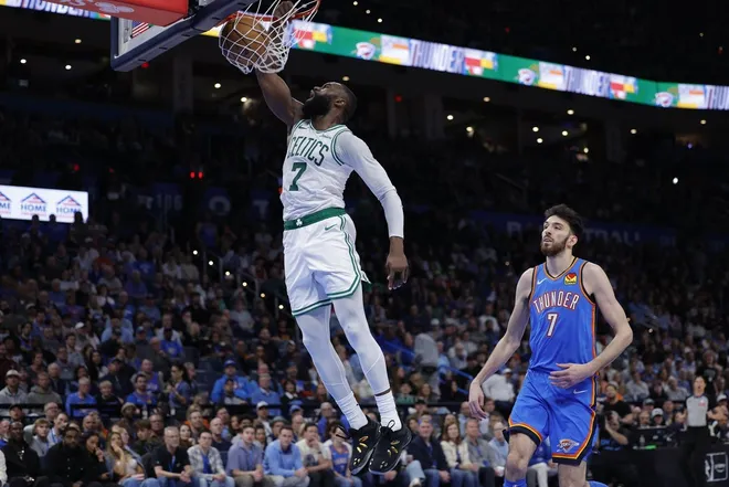 Mar 12, 2026; Oklahoma City, Oklahoma, USA; Boston Celtics guard/forward Jaylen Brown (7) goes up for a dunk in front of Oklahoma City Thunder center/forward Chet Holmgren (7) during the fourth quarter at Paycom Center.