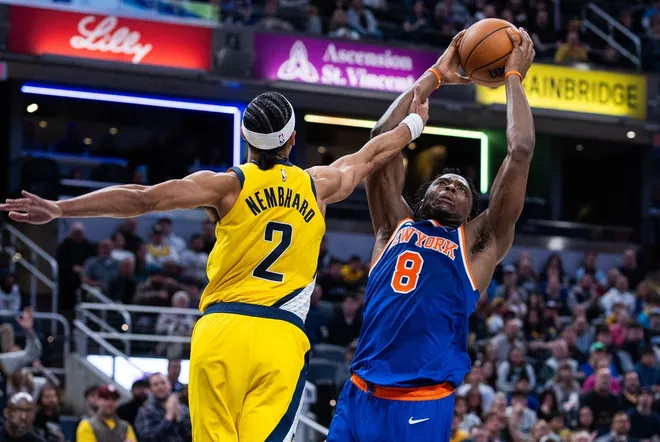 Mar 13, 2026; Indianapolis, Indiana, USA; New York Knicks forward/guard Og Anunoby (8) shoots the ball while Indiana Pacers guard/forward Andrew Nembhard (2) as defends in the second half at Gainbridge Fieldhouse.