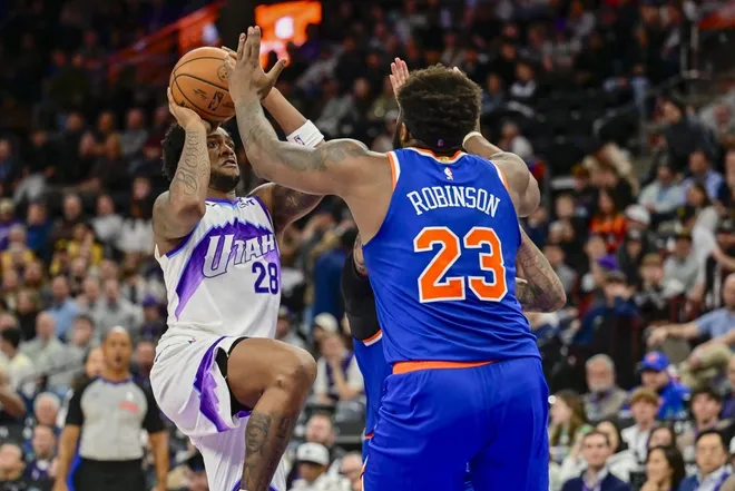 Mar 11, 2026; Salt Lake City, Utah, USA; Utah Jazz forward Brice Sensabaugh (28) shoots the ball over New York Knicks center/forward Mitchell Robinson (23) during the second half at Delta Center.