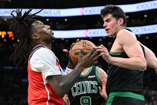 Mar 14, 2026; Boston, Massachusetts, USA; Boston Celtics guard Baylor Scheierman (55) and Washington Wizards guard Jamir Watkins (5) battle for the ball during the first half at the TD Garden. Mandatory Credit: Brian Fluharty-Imagn Images