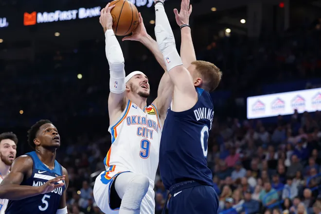 Mar 15, 2026; Oklahoma City, Oklahoma, USA; Oklahoma City Thunder guard Alex Caruso (9) goes to the basket as Minnesota Timberwolves guard Donte DiVincenzo (0) defends during the first half at Paycom Center. Mandatory Credit: Alonzo Adams-Imagn Images