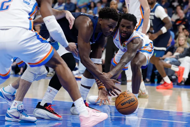 Mar 15, 2026; Oklahoma City, Oklahoma, USA; Minnesota Timberwolves guard Anthony Edwards (5) and Oklahoma City Thunder guard Cason Wallace (22) fight for a loose ball during the second half at Paycom Center. Mandatory Credit: Alonzo Adams-Imagn Images