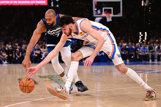 OKLAHOMA CITY, OKLAHOMA - MARCH 15: Chet Holmgren #7 of the Oklahoma City Thunder and Rudy Gobert #27 of the Minnesota Timberwolves go for a loose ball during the first half at Paycom Center on March 15, 2026 in Oklahoma City, Oklahoma. NOTE TO USER: User expressly acknowledges and agrees that, by downloading and or using this photograph, User is consenting to the terms and conditions of the Getty Images License Agreement. (Photo by Joshua Gateley/Getty Images)