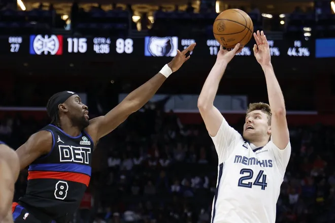 Mar 13, 2026; Detroit, Michigan, USA; Memphis Grizzlies guard Cam Spencer (24) shoots on Detroit Pistons guard Caris LeVert (8) in the second half at Little Caesars Arena.