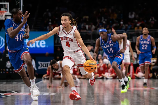 Mar 13, 2026; Kansas City, MO, USA; Houston Cougars guard Kingston Flemings (4) brings the ball up court around Kansas Jayhawks forward Flory Bidunga (40) during the first half at T-Mobile Center. Mandatory Credit: William Purnell-Imagn Images