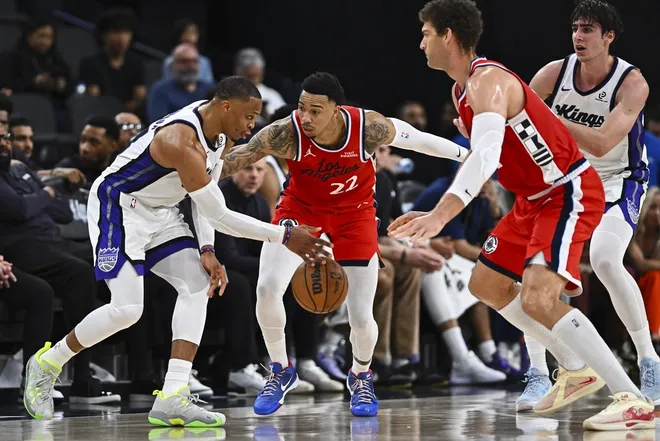 Mar 14, 2026; Inglewood, California, USA; Sacramento Kings guard Russell Westbrook (18) dribbles the ball against LA Clippers guard Jordan Miller (22) and center Brook Lopez (11) during the second quarter at Intuit Dome.