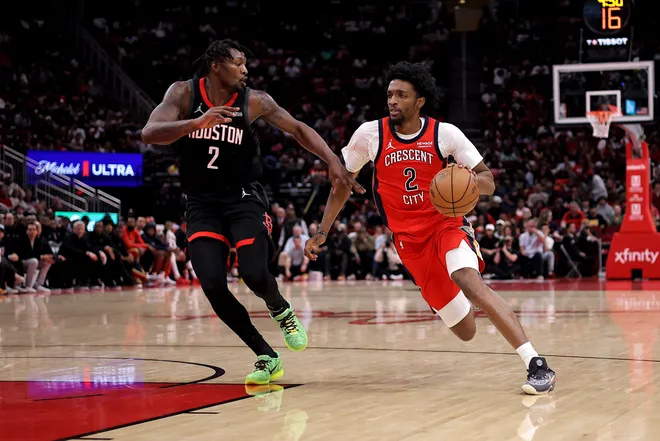 Mar 13, 2026; Houston, Texas, USA; New Orleans Pelicans forward Herbert Jones (2) drives to the basket against Houston Rockets forward Dorian Finney-Smith (2) during the game at Toyota Center. Mandatory Credit: Erik Williams-Imagn Images