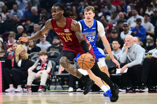 Mar 15, 2026; Cleveland, Ohio, USA; Cleveland Cavaliers guard Keon Ellis (14) drives to the basket against Dallas Mavericks forward Cooper Flagg (32) during the second half at Rocket Arena. Mandatory Credit: Ken Blaze-Imagn Images