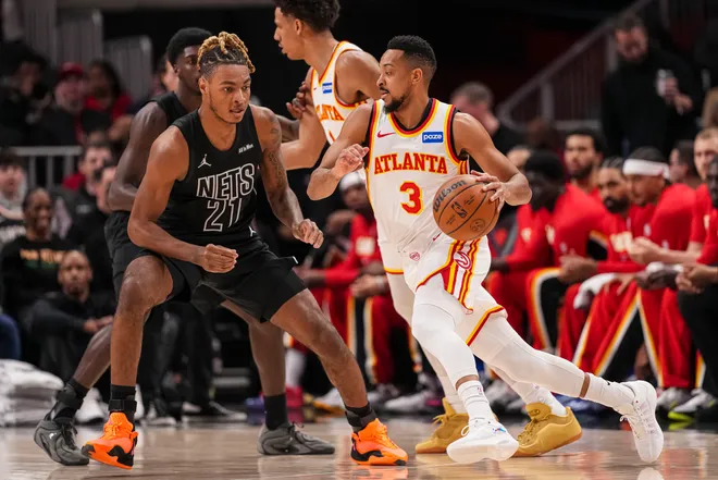 Mar 12, 2026; Atlanta, Georgia, USA; Atlanta Hawks guard CJ McCollum (3) dribbles against Brooklyn Nets forward Noah Clowney (21) during the first half at State Farm Arena. Mandatory Credit: Dale Zanine-Imagn Images