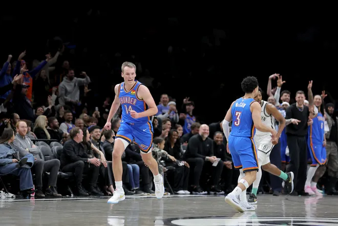 Mar 18, 2026; Brooklyn, New York, USA; Oklahoma City Thunder forward Payton Sandfort (14) reacts after making a three point basket against the Brooklyn Nets during the fourth quarter at Barclays Center. Mandatory Credit: Brad Penner-Imagn Images