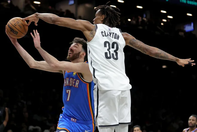 Mar 18, 2026; Brooklyn, New York, USA; Brooklyn Nets center Nic Claxton (33) blocks a shot by Oklahoma City Thunder center Chet Holmgren (7) during the second quarter at Barclays Center. Mandatory Credit: Brad Penner-Imagn Images