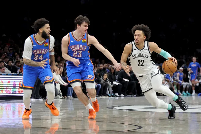 Mar 18, 2026; Brooklyn, New York, USA; Brooklyn Nets forward Jalen Wilson (22) drives to the basket against Oklahoma City Thunder forward Brooks Barnhizer (23) and guard Kenrich Williams (34) during the fourth quarter at Barclays Center. Mandatory Credit: Brad Penner-Imagn Images