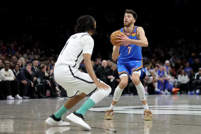 Mar 18, 2026; Brooklyn, New York, USA; Oklahoma City Thunder center Chet Holmgren (7) shoots a three point shot against Brooklyn Nets forward Ziaire Williams (1) during the second quarter at Barclays Center. Mandatory Credit: Brad Penner-Imagn Images