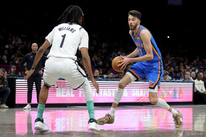 Mar 18, 2026; Brooklyn, New York, USA; Oklahoma City Thunder center Chet Holmgren (7) controls the ball against Brooklyn Nets forward Ziaire Williams (1) during the second quarter at Barclays Center. Mandatory Credit: Brad Penner-Imagn Images