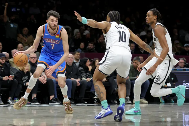 Mar 18, 2026; Brooklyn, New York, USA; Oklahoma City Thunder center Chet Holmgren (7) controls the ball against Brooklyn Nets guard Tyson Etienne (10) and center Nic Claxton (33) during the second quarter at Barclays Center. Mandatory Credit: Brad Penner-Imagn Images