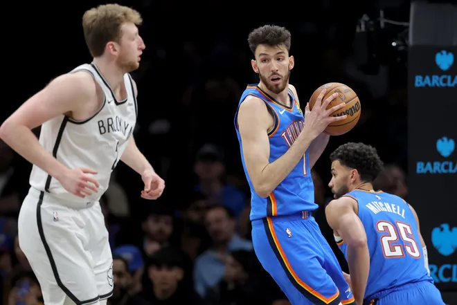 Mar 18, 2026; Brooklyn, New York, USA; Oklahoma City Thunder center Chet Holmgren (7) controls the ball against Brooklyn Nets forward Danny Wolf (2) during the second quarter at Barclays Center. Mandatory Credit: Brad Penner-Imagn Images