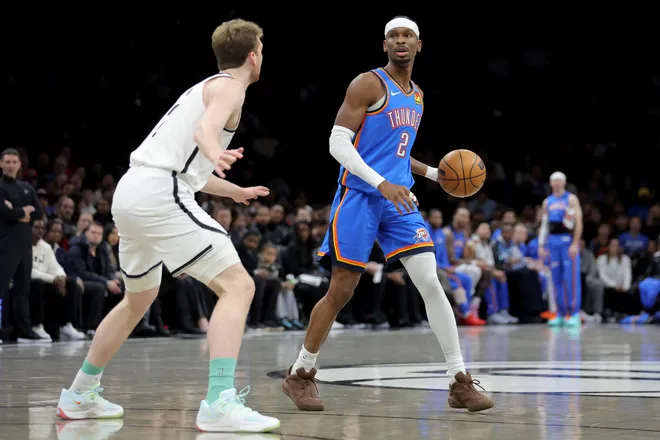 Mar 18, 2026; Brooklyn, New York, USA; Oklahoma City Thunder guard Shai Gilgeous-Alexander (2) controls the ball against Brooklyn Nets forward Danny Wolf (2) during the first quarter at Barclays Center. Mandatory Credit: Brad Penner-Imagn Images