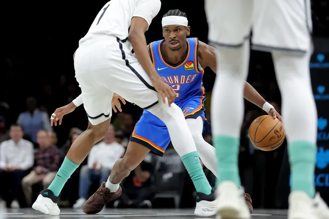 Mar 18, 2026; Brooklyn, New York, USA; Oklahoma City Thunder guard Shai Gilgeous-Alexander (2) controls the ball against Brooklyn Nets forward Ziaire Williams (1) during the first quarter at Barclays Center. Mandatory Credit: Brad Penner-Imagn Images