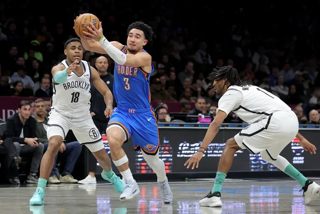 Mar 18, 2026; Brooklyn, New York, USA; Oklahoma City Thunder guard Jared McCain (3) drives to the basket against Brooklyn Nets guard Malachi Smith (18) and forward Ziaire Williams (1) during the first quarter at Barclays Center. Mandatory Credit: Brad Penner-Imagn Images