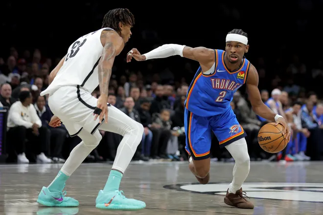 Mar 18, 2026; Brooklyn, New York, USA; Oklahoma City Thunder guard Shai Gilgeous-Alexander (2) drives to the basket against Brooklyn Nets center Nic Claxton (33) during the first quarter at Barclays Center. Mandatory Credit: Brad Penner-Imagn Images